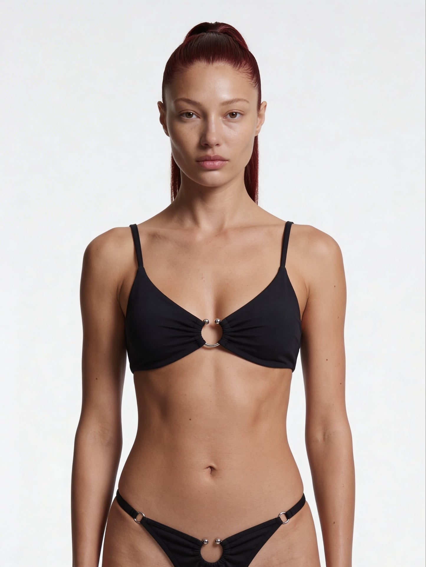 Woman wearing a black pierce top with a cut out